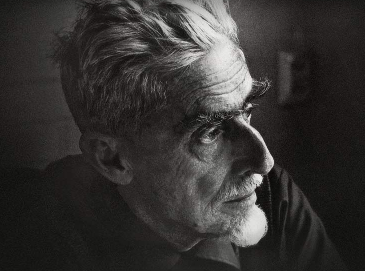 A black and white photograph/headshot of Escher in his 70's.